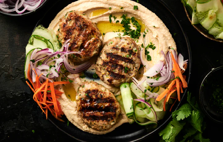 Elevate your mealtime with these delicious and nutritious Chicken Koftas served with creamy hummus and fresh veggies.